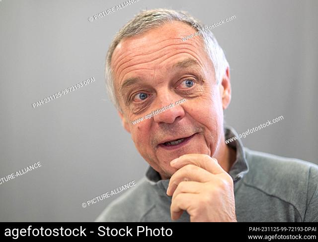24 November 2023, Saxony, Dresden: Norbert Loch, national luge coach, stands on the sidelines of the press conference of the German Bobsleigh and Luge...