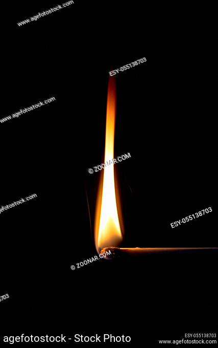 An image of a match flame dark background