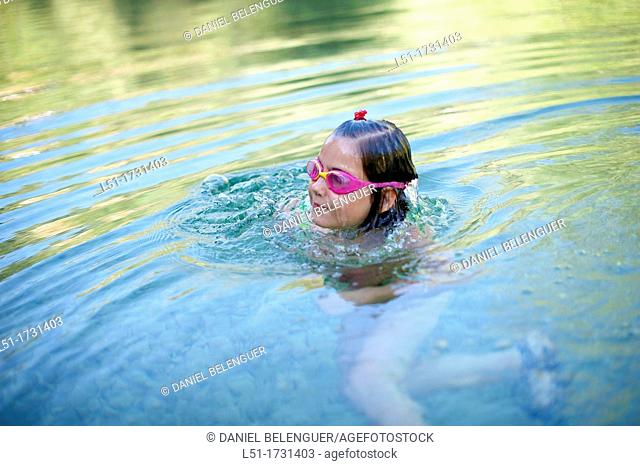 girl with underwater glasses swimming on a river , Villahermosa river, Ludiente, Castellón, Spain