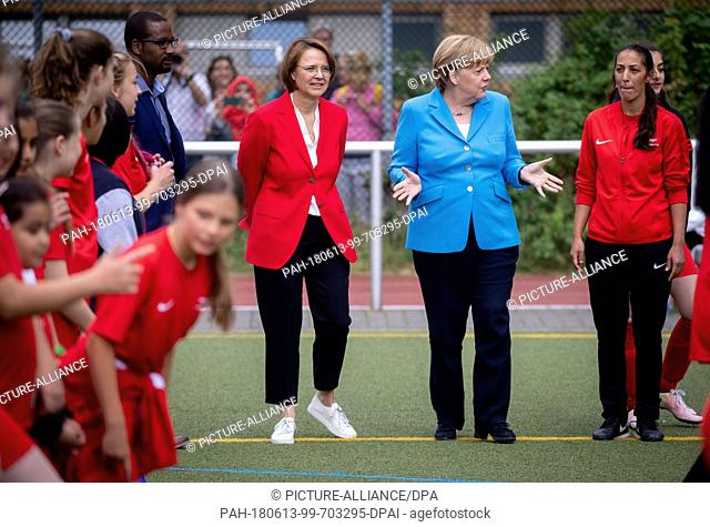 13 June 2018, Berlin, Germany: Chancellor Angela Merkel (Christian Democratic Union - CDU, 2-R) watches young athletes of SV Rot-Weiß Viktoria Mitte 08 with...