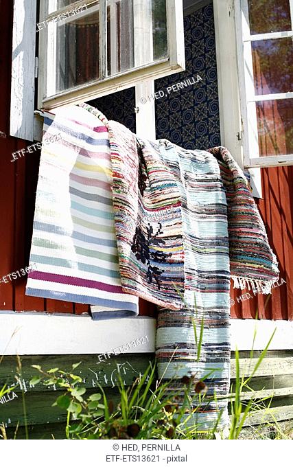 Rugs Hanging Out From A Window Sweden