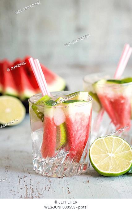 Fresh mineral water with watermelon, lime and ice in glasses