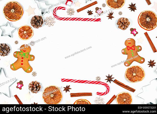 Christmas food frame. Gingerbread cookies, spices and decorations on white background with copy space