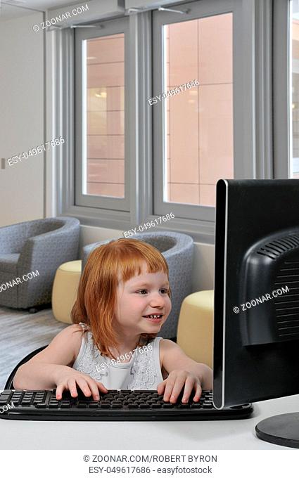 Computer savvy little girl using a desktop computer