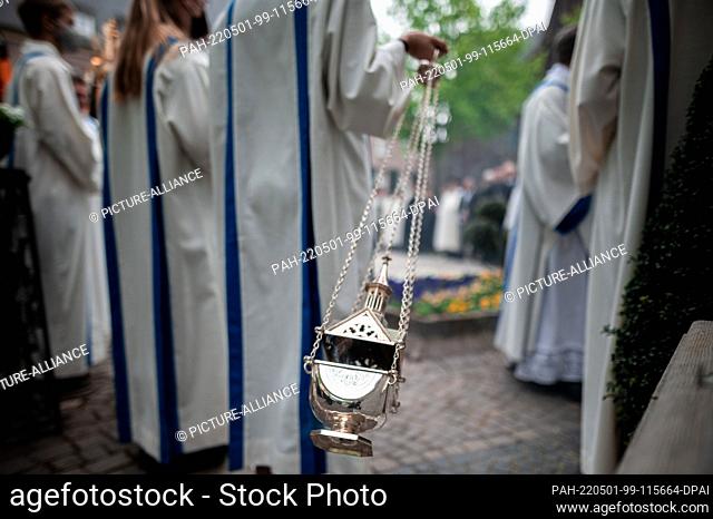 01 May 2022, North Rhine-Westphalia, Kevelaer: An altar girl waves a barrel of incense. For 375 years, the opening of Germany's second largest pilgrimage has...