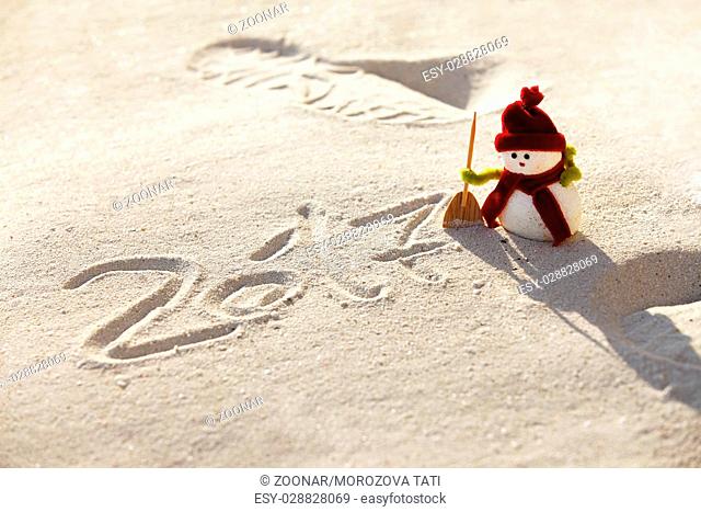 Toy snowman on the sand