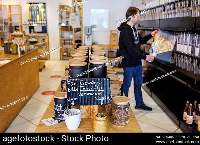 PRODUCTION - 16 March 2023, Bavaria;Bavaria, Nuremberg: ""Please use teaspoons for spices"" is written on a sign on a food jar at the unpackaged store Zero Hero