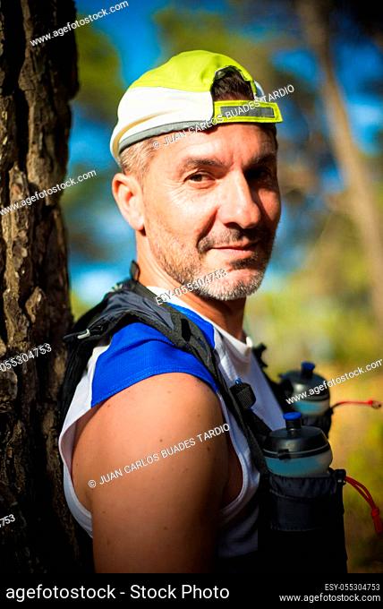 Photography session of trail runner runnig in the middle of nature and in the mountains. Preparing and interviewing