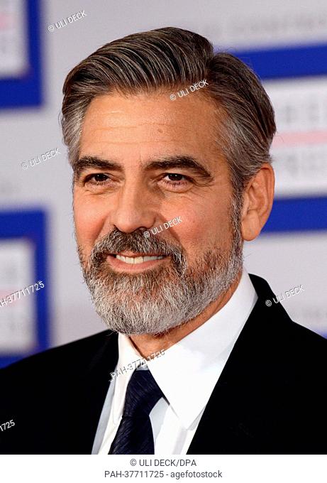 US actor George Clooney poses after receiving the German Media Prize 2012 at the award ceremony with Karlheinz Koegel of Media Control in Baden-Baden, Germany