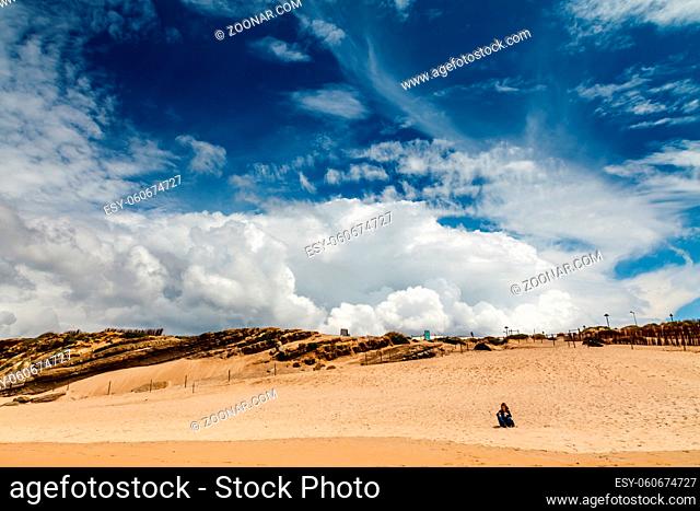 Woman Meditating on Guincho Beach under Amazing Sky, Cascais, Portugal