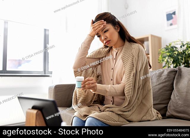 sick woman with medicine has video consultation