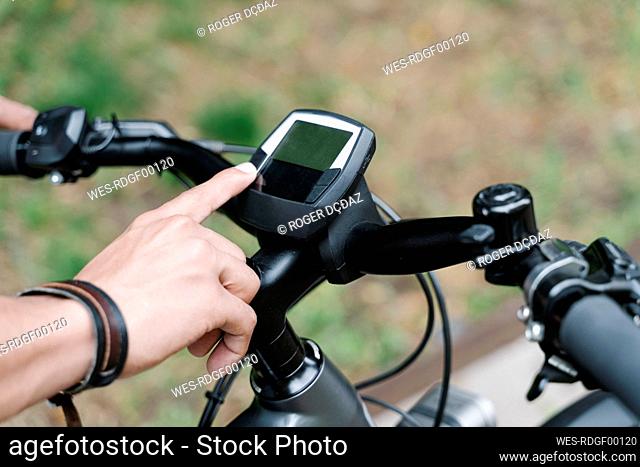 Man using GPS navigator on electric bicycle
