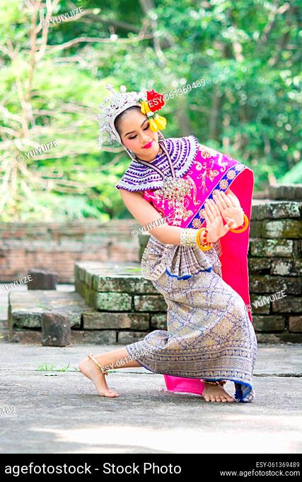 Asian woman wearing typical, traditional Thai Dress. It is literally means ""Thai outfit"", National costume and dancing