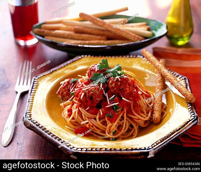 Spaghetti with meatballs, tomato sauce and sesame sticks