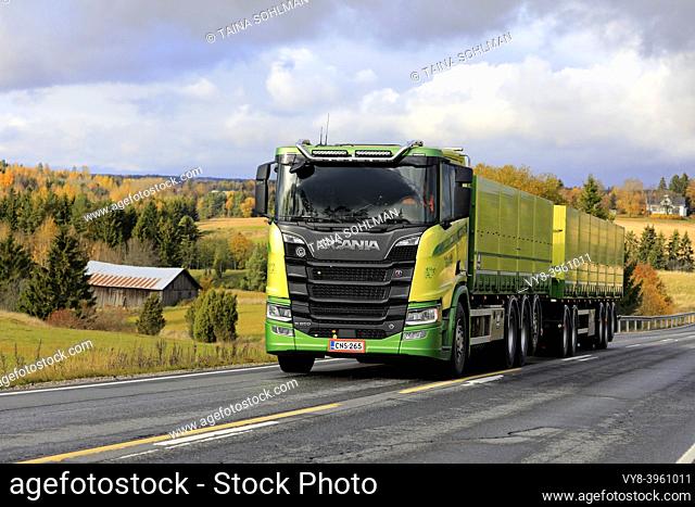 New, green Scania R650 truck of Kuljetus Saarinen Oy in seasonal sugar beet haul on scenic autumnal road in Salo, Finland. October 12, 2019