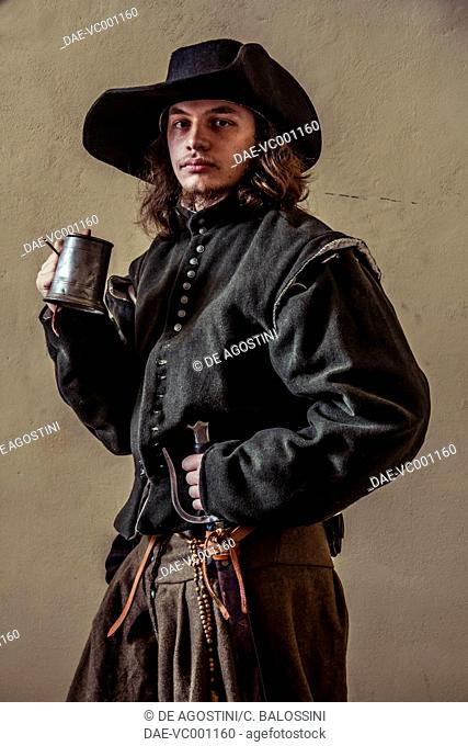 Swordsman with a wide-brimmed hat and mug. Italy, 16th century. Historical reenactment