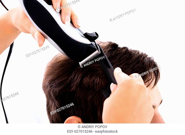 Hairdresser Cutting Person's Hair With Electric Trimmer