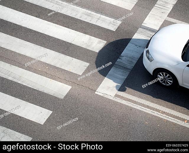 Top View of a Pedestrian Crosswalk with White Car