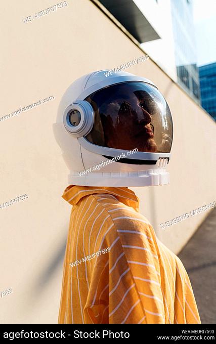 Woman wearing space helmet on sunny day