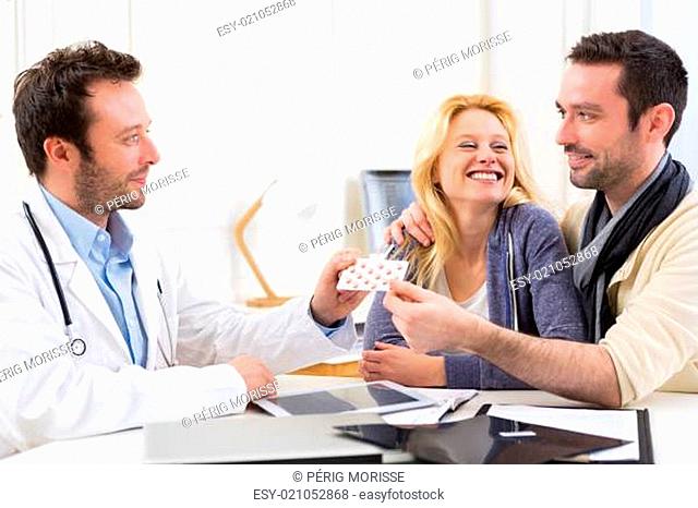 Doctor gives pills to couple of patient