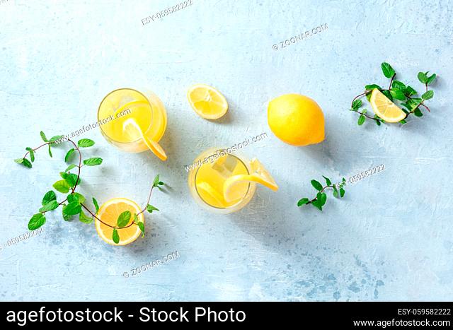 Lemonade. Homemade fresh drink with lemon and mint, overhead flat lay shot. Healthy citrus detox ice tea. Healthy organic detox