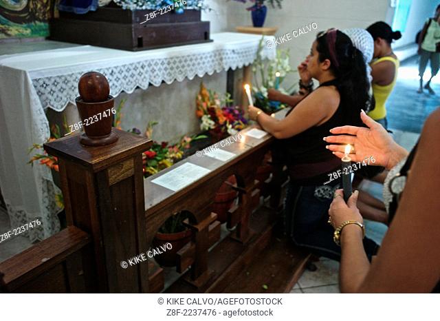 Cuban devotees bringing candles and praying to the Virgin de Regla or Yemaya, Goddess of the Sea