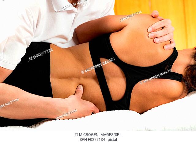 Osteopath performing spinal manipulation