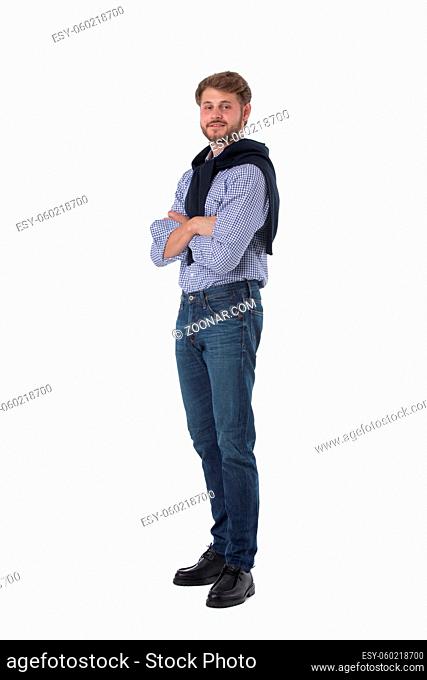 Handsome young man standing with arms folded full length portrait isolated on white background