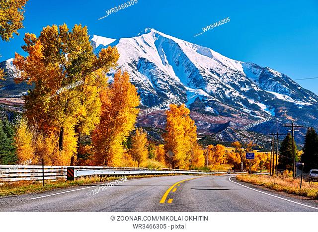 Highway in Colorado Rocky Mountains at autumn, USA. Mount Sopris landscape