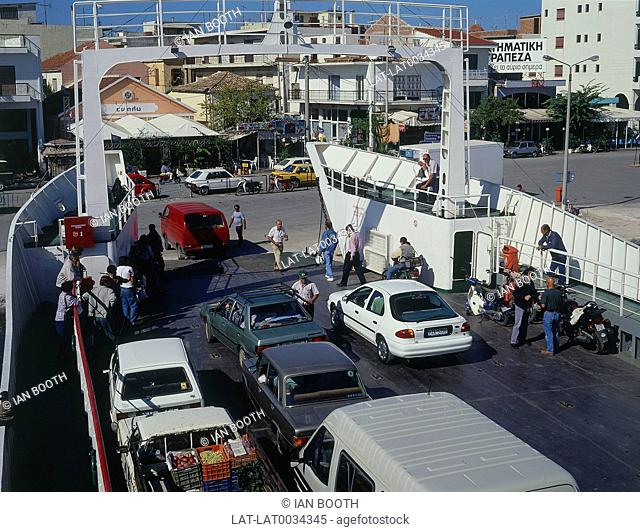 Ferry Preveza unloading cars and people. Quayside shops in background. Sporades