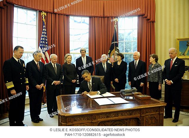 United States President Barack Obama signs the New START Treaty during a ceremony in the Oval Office of the White House, with, from left