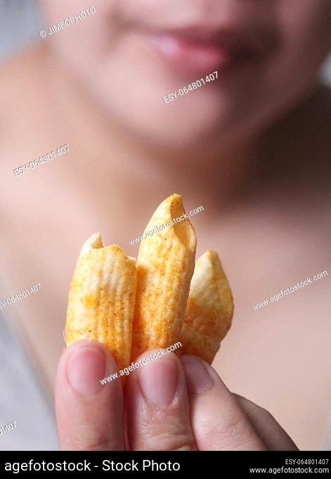 Woman holding crispy cornflakes for eat, It is a popular street food that is delicious and commonly found in Asian countries such as Thailand, China, Laos