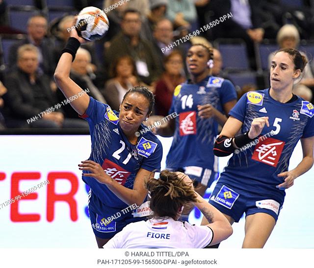 France's Estelle Nze Minko (L) throws the ball at the opposing team's goal during the World Women's Handball Championship match between France and Paraguay in...