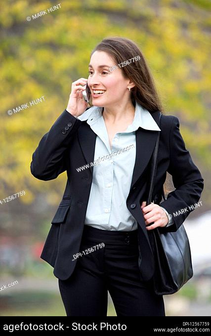 View of a business woman talking on the phone and smiling