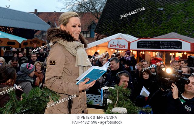 The wife of the former German President, Bettina Wulff, reads her favorite Christmas tale 'Pelle moves out' by Astrid Lindgren at the Christmas market on the...