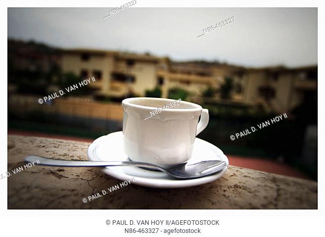 Coffee cup and saucer on ledge in Sicily. Italy