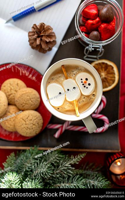 marshmallow snowman in cup of coffee on christmas