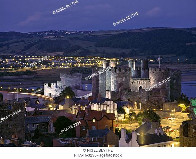 Floodlit Conwy Castle, UNESCO World Heritage Site, overlooking the town with the River Conwy estuary beyond at dusk, Gwynedd, North Wales, United Kingdom