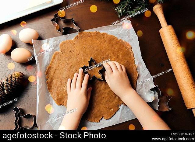 Little girl is baking christmas gingerbread cookies. High quality photo