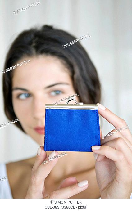 A female looking at a purse