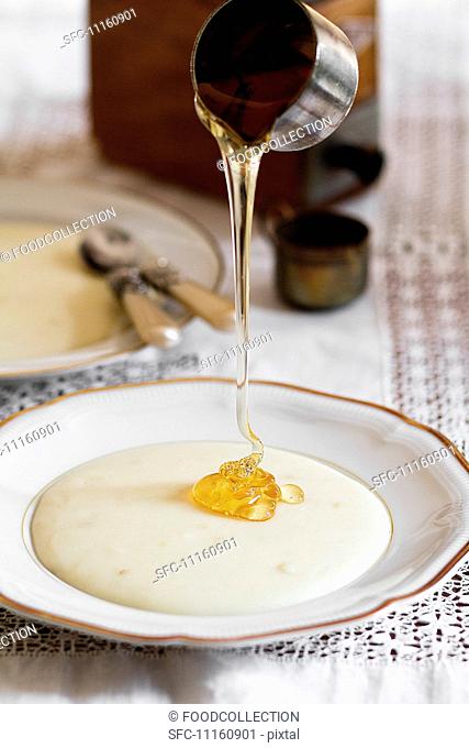Honey being drizzled over porridge