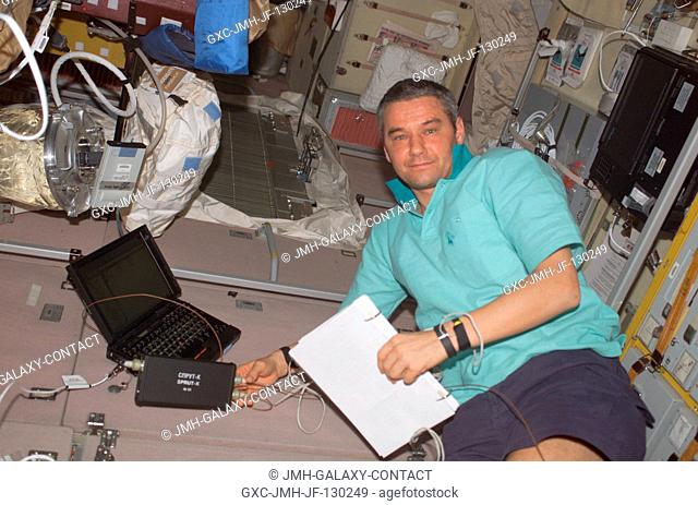 Cosmonaut Valery G. Korzun, Expedition Five mission commander representing Rosaviakosmos, works in the Zvezda Service Module on the International Space Station...