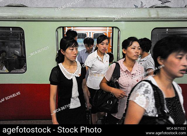 Pyongyang, North Korea, Asia - Commuters leave a subway train of the Pyongyang Metro at an underground station in the centre of the North Korean capital city