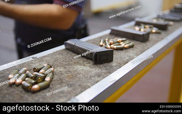 Pistol clips with bullets in shooting gallery, close up