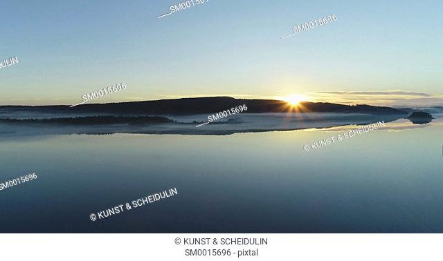 Sunrise at a quiet lake in northern Sweden - aerial shot