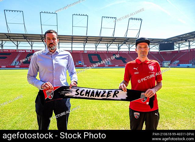 18 June 2021, Bavaria, Ingolstadt: Roberto Pätzold (r), the new coach at FC Ingolstadt, holds a fan scarf with the inscription Schanzer at the football club's...