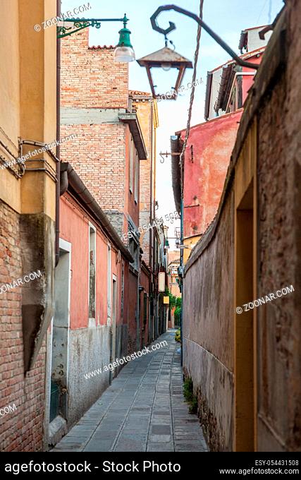 Venetian buildings represented onnarrow street in Italy. Narrow road in Venice, Italy