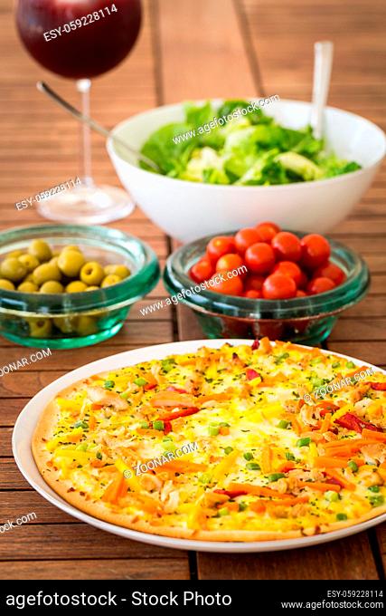 Thai pizza with vegetables and salad