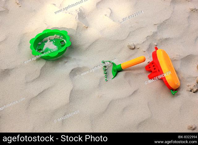 Colourful plastic children's toys in a sandbox, playground