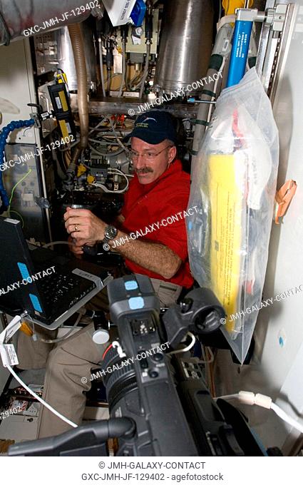 NASA astronaut Dan Burbank, Expedition 30 flight commander, performs the Waste and Hygiene Compartment (WHC) yearly maintenance in the Tranquility node of the...